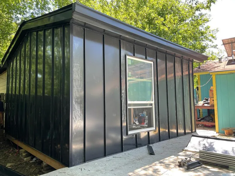 Black standing seam metal wall panels for Roof Inspection in Grain Valley